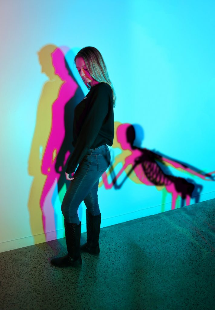 A girl in the museum of Illusions with the wall making illusions