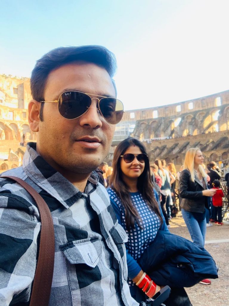 A couple inside Colosseum during their trip to Italy