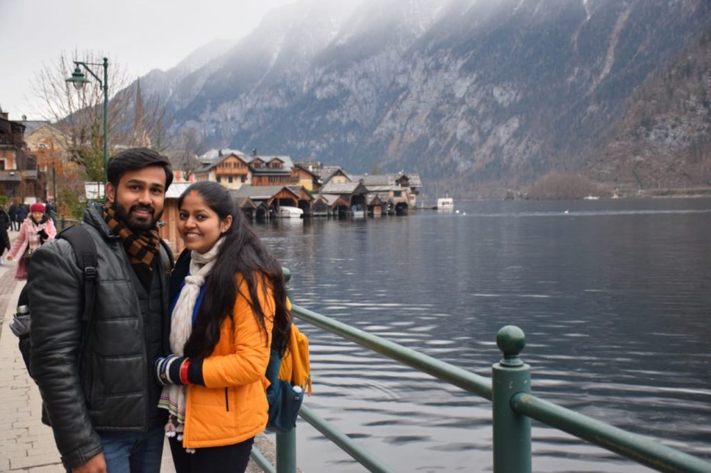 A couple posing in Hallstat. Salzburg on their honeymoon trip