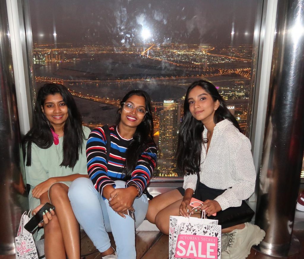 Three friends posing for a picture after shopping