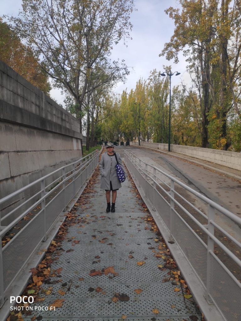 A picture of a girl standing in the picturesque roads of Europe