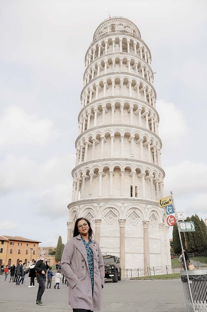 A girl posing in front of the Pisa in Florence on their honeymoon to Italy