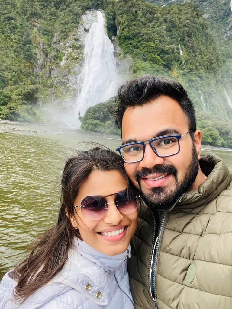 A couple clicking a selfie with waterfalls background