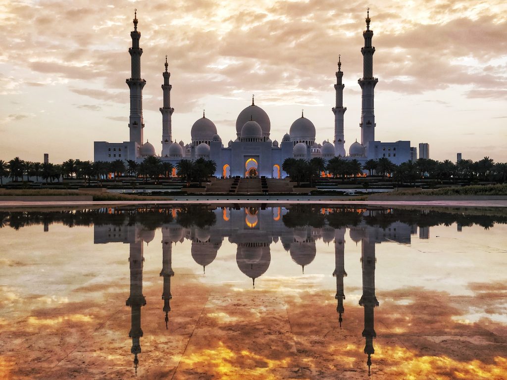 Majestic Reflections of Sheikh Zayed Grand Mosque and fiery golden sky