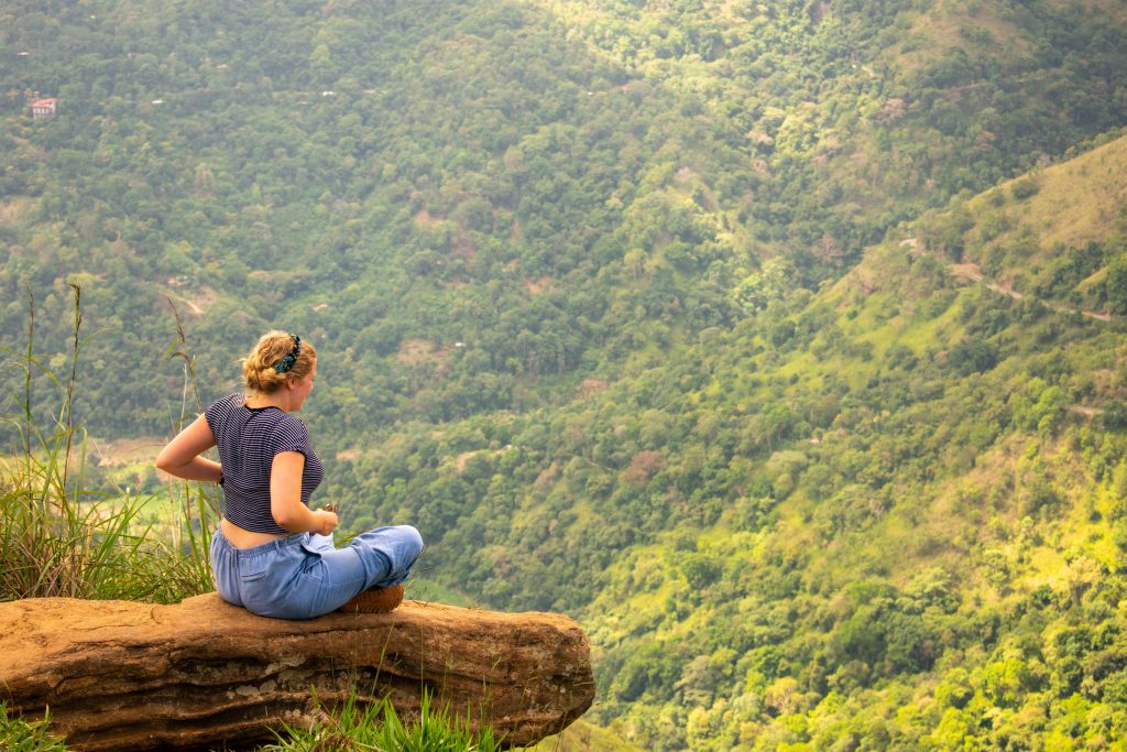 A woman sitting on one of the footprints of Buddha