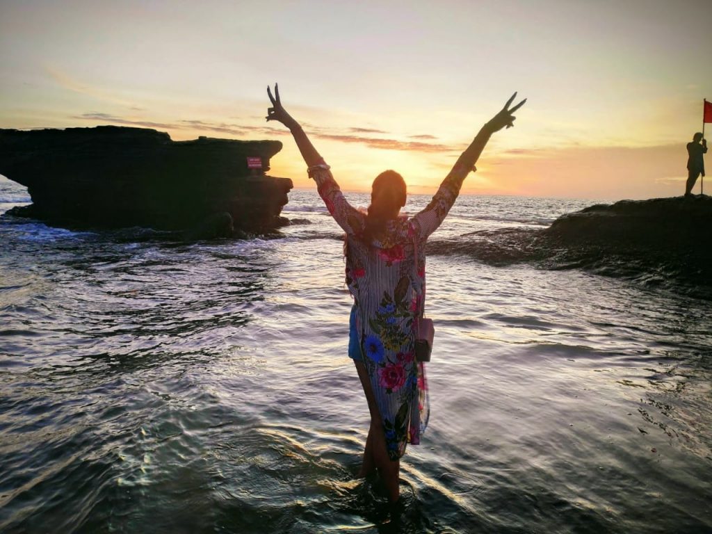 A girl posing the symbol of peace in Bali