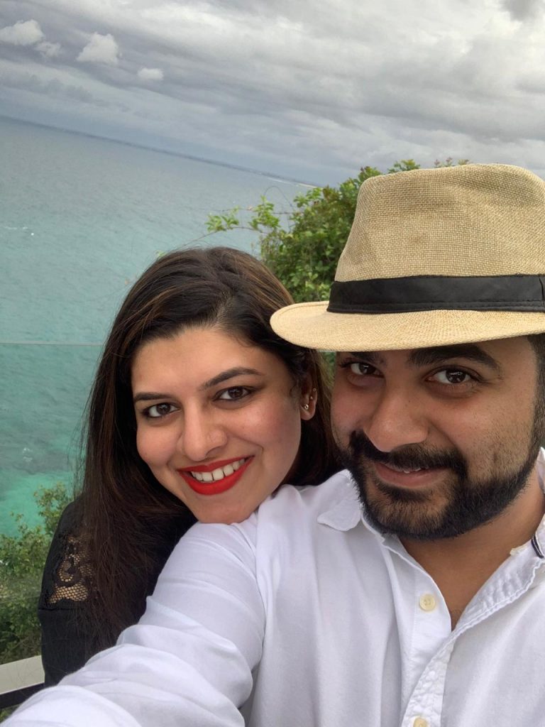 An amazing picture of a couple with crystal clear waters as the backdrop