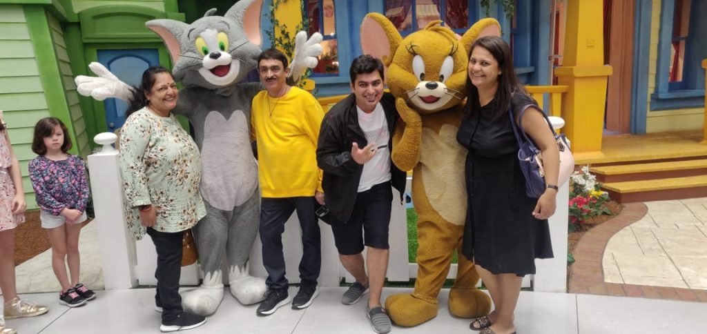 A group of people posing with the Mickey mouse on their trip to Dubai
