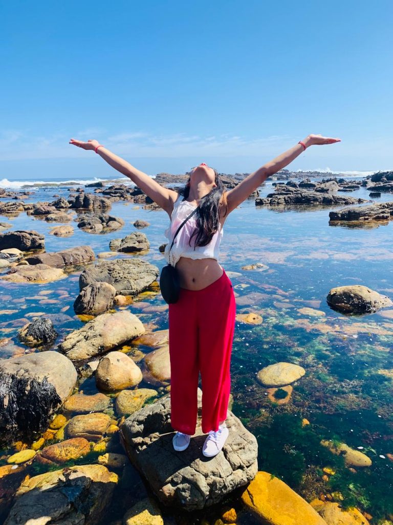 An awesome picture of a woman posing at the beach on her honeymoon trip to South Africa