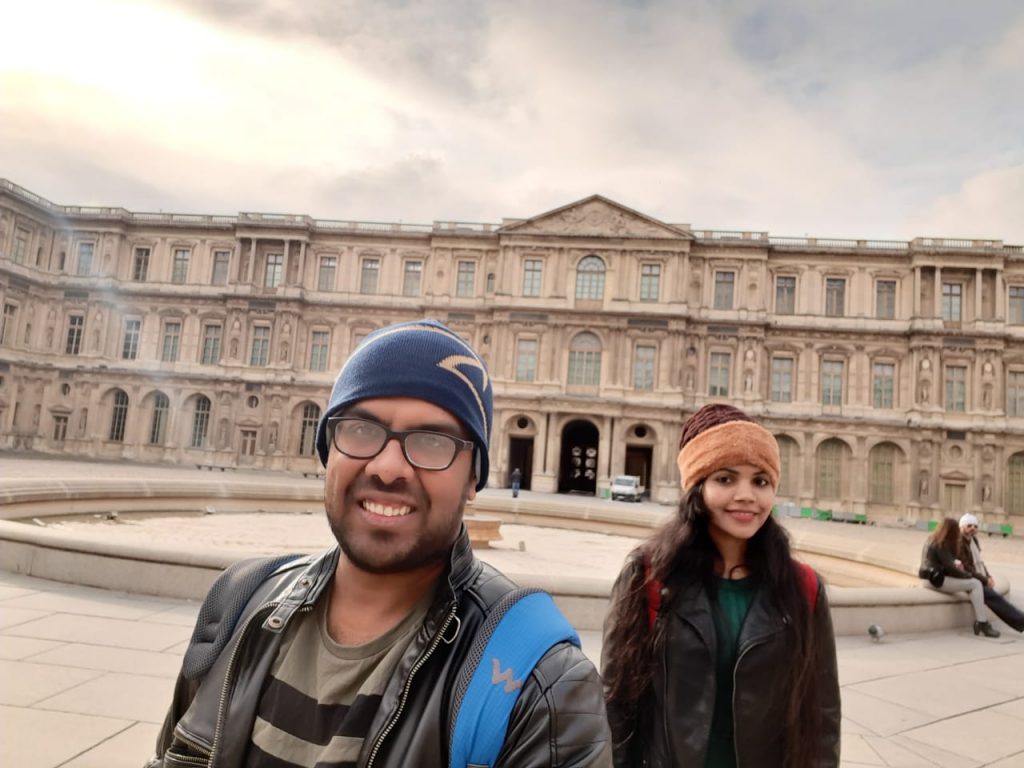 A picture of a couple posing in Paris on their honeymoon vacation to Europe