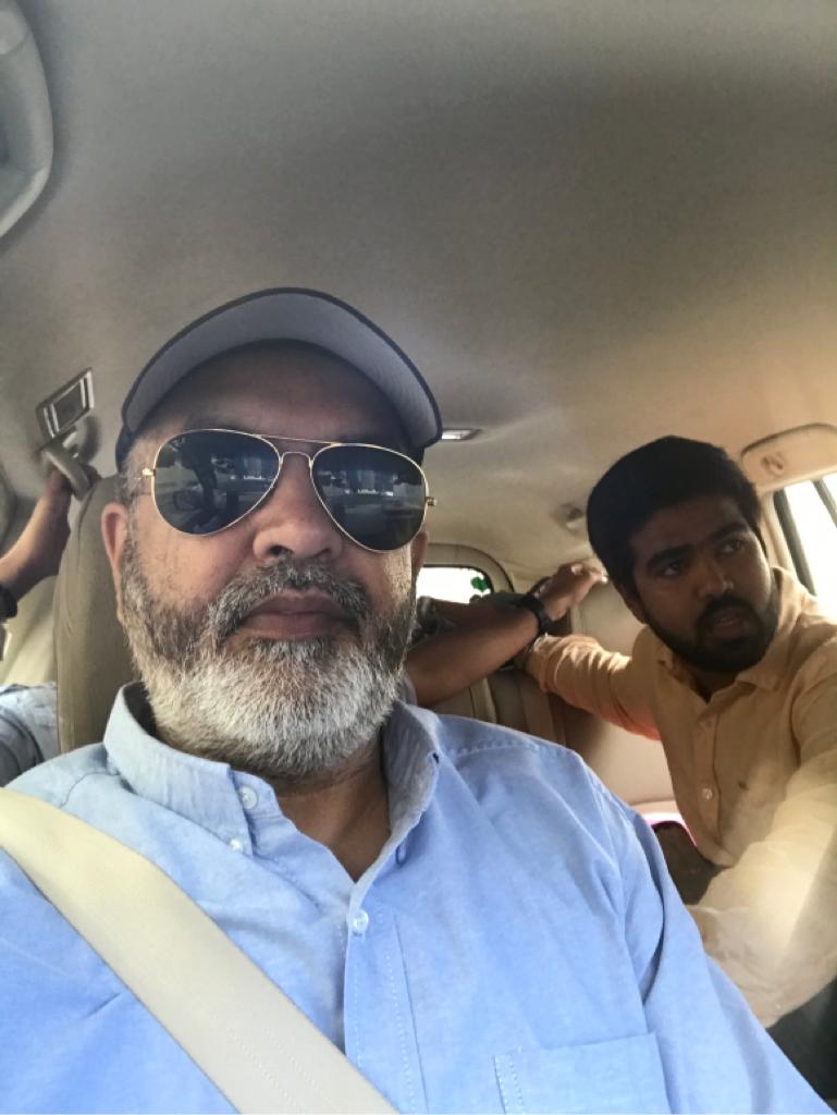 A picture of two people sitting in the car