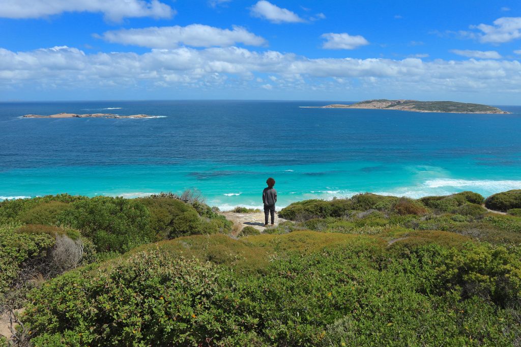 A picture of a guy standing in a beach in Esperance