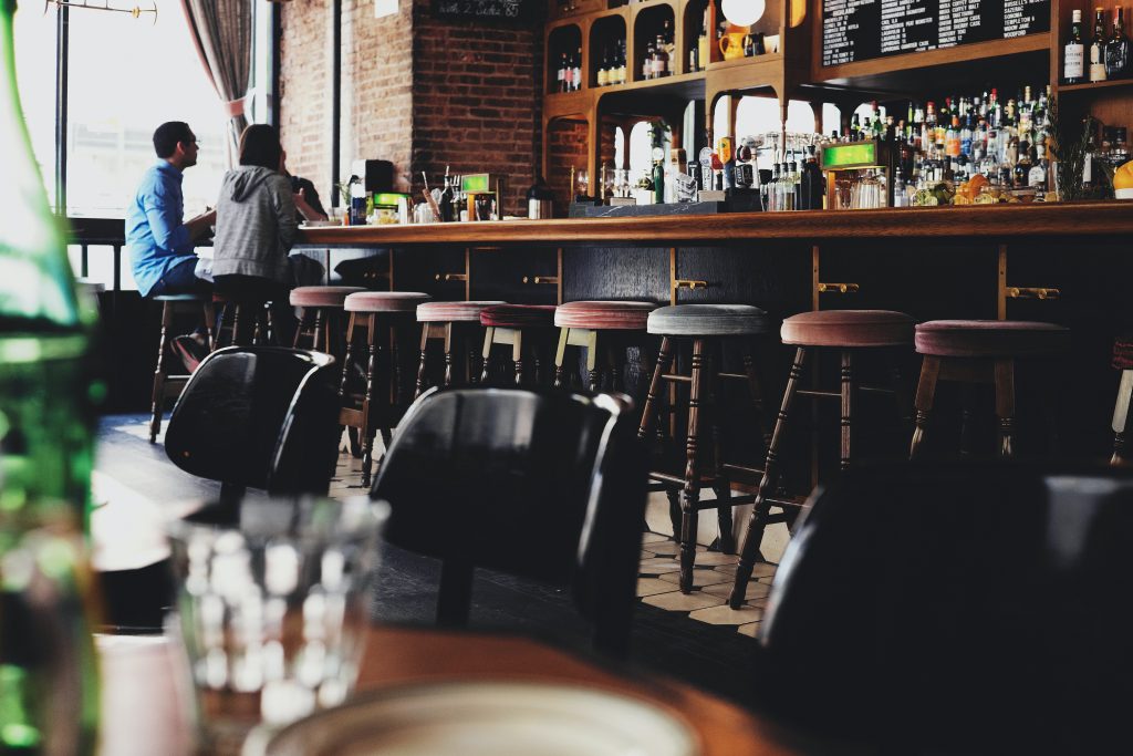 A pub with two people sitting on chairs