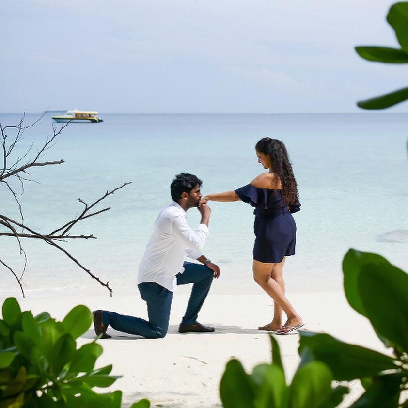 A guy kissing a girl's hand